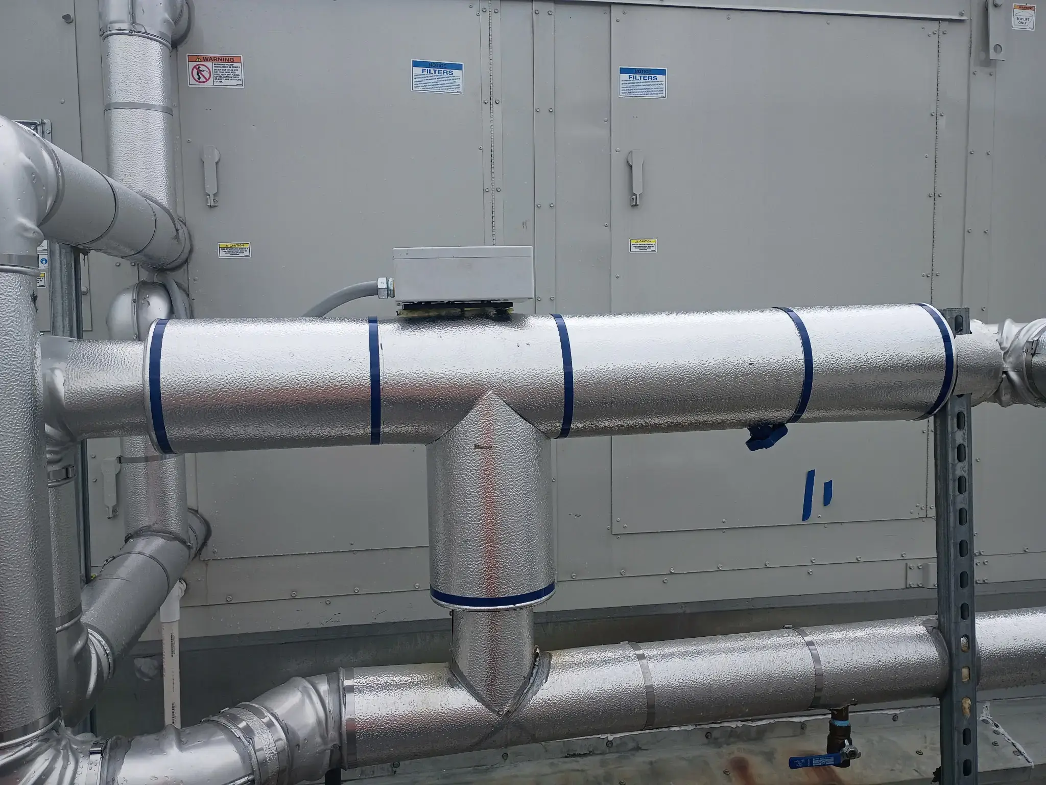 Metal-jacketed pipe insulation installed by Patriot Scaffolding & Insulation in Tulsa, Oklahoma
